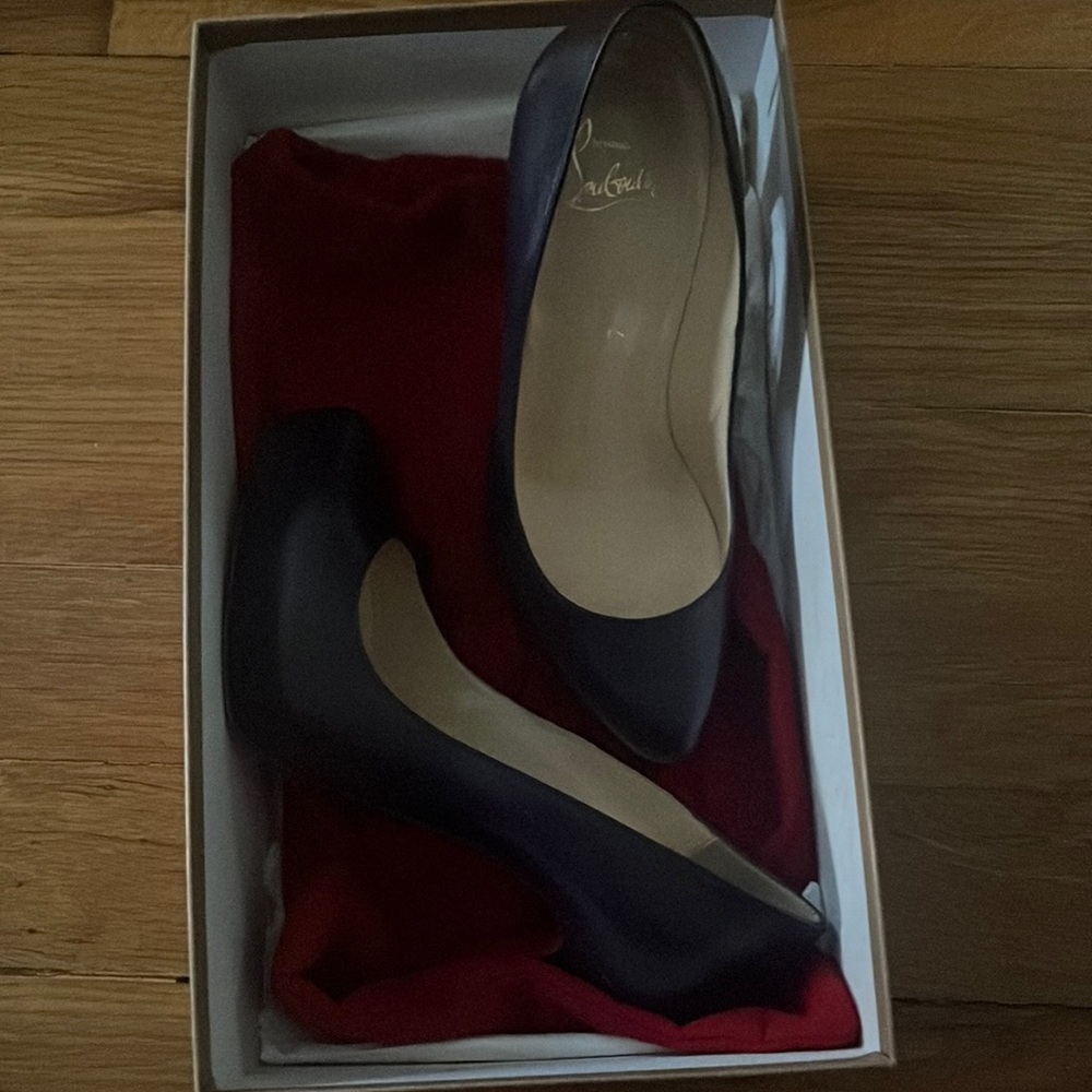 Christian louboutin purple heels with zipper look on the back of them